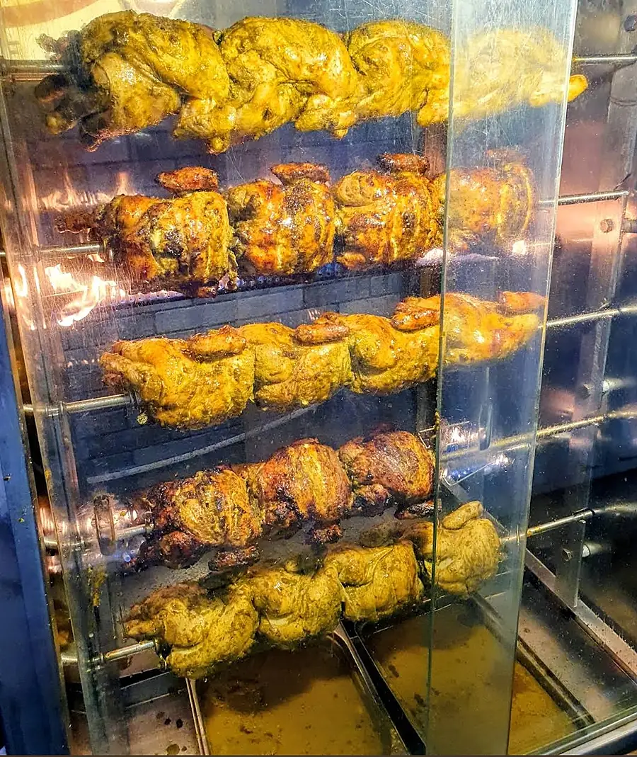 Rotisserie chickens turning at MD Grill Cafeteria